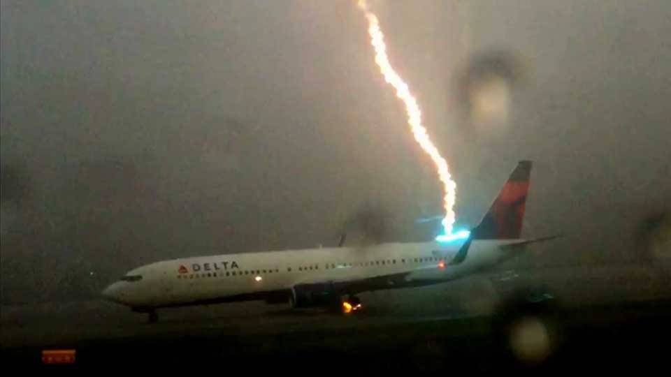 While filming the line of planes all piled up amid a ground hold in Atlanta on 8/18/15 because of heavy rain and thunderstorm, this guy happened to capture this direct lightning strike on a 737.