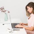 Woman in Pink Dress Using Laptop Computer