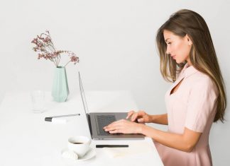 Woman in Pink Dress Using Laptop Computer